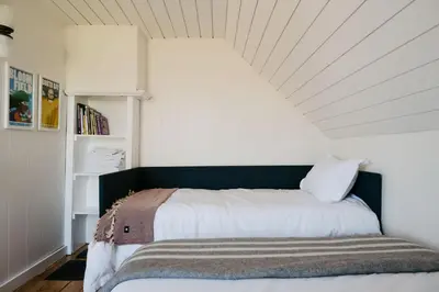 a bedroom with a bed with a white ceiling at Park and Mill - Hot Tub and Bocce Court in Bloomfield