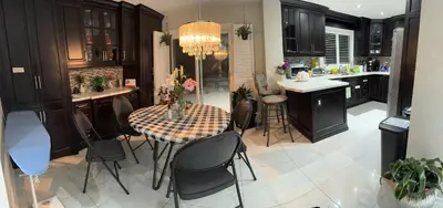 a kitchen with a table and chairs in a kitchen at F2 Comfy Private Room in city square one in Mississauga