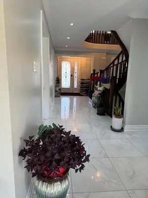 a hallway with a vase with flowers in it at F2 Comfy Private Room in city square one in Mississauga