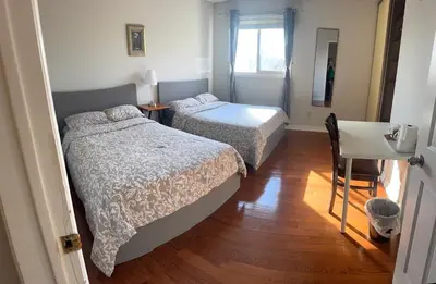 a bedroom with two beds and a table and a desk at 201 Large Private Bedroom on second floor in Mississauga