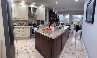 a kitchen with white cabinets and a large island at 201 Large Private Bedroom on second floor in Mississauga