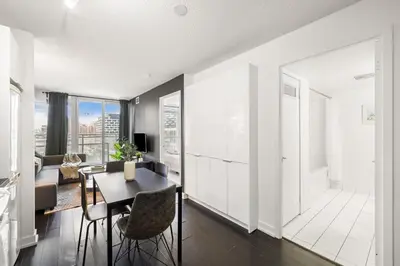 a kitchen and living room with a table and chairs at Modern 1BR King Suite, Central Downtown Toronto in Toronto