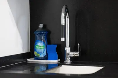 a bottle of cleaning detergent sitting next to a sink at Modern 1BR King Suite, Central Downtown Toronto in Toronto