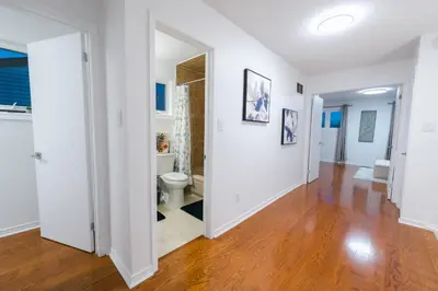 an empty living room with a toilet and a hallway at Spacious 4 bedroom Home - 15 mins from YYZ airport in Mississauga