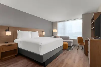a hotel room with a large bed and a window at Hyatt House Mississauga / Airport Corp Center in Mississauga