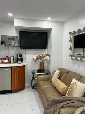 a living room with a couch and a tv at St Catharines Niagara Escape in St. Catharines