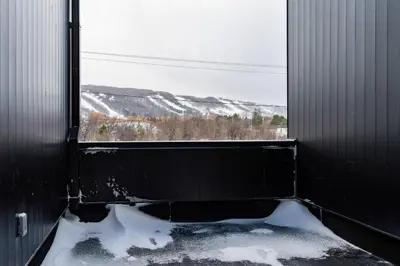 a window in a room with snow on the ground at White Rose Chalet at Blue Mountains for 20 w Hot Tub in Blue Mountains