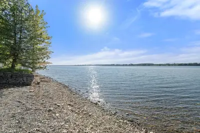 a rocky shore of a large body of water at The Cattail - 26 Meadowview in Cherry Valley