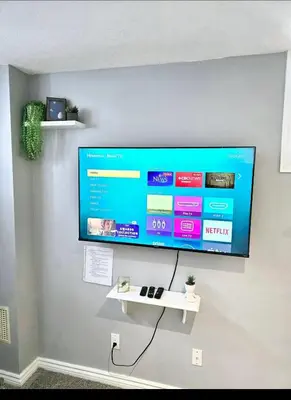 a flat screen tv hanging on a wall at Welcome to your Serene Gateway in London