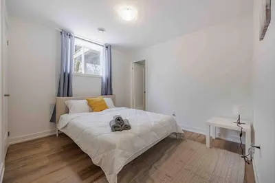 a bedroom with a bed with a stuffed animal on it at Cozy 2Bed Home 6 minutes to the FALLS! in Niagara Falls