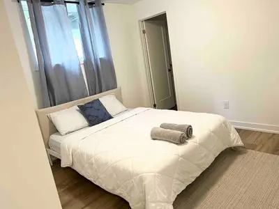 a bedroom with a bed with two towels on it at Cozy 2Bed Home 6 minutes to the FALLS! in Niagara Falls