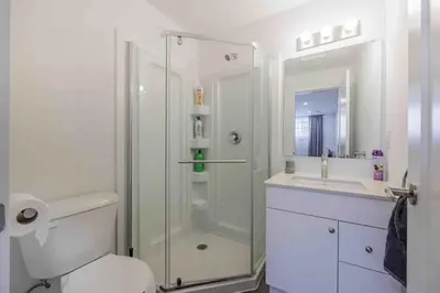 a bathroom with a shower and a toilet and a sink at Cozy 2Bed Home 6 minutes to the FALLS! in Niagara Falls