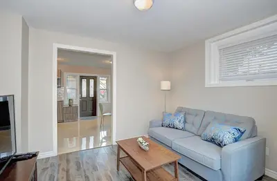 a living room with a couch and a table at Spacious Modern Condo In Kitchener in Kitchener