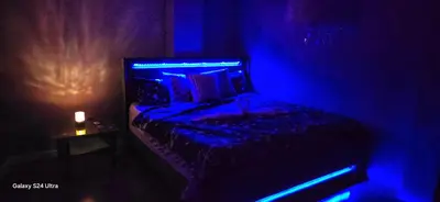 a dark room with a bed with blue lights at 70 percent Off Luxurious Hot Tub,Sauna, 2000Sqft of Private in Vaughan