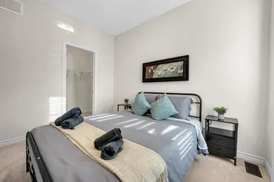 a bedroom with a bed with two towels on it at Spacious 6bed Home near Pier Niagara Toronto QEW in Burlington