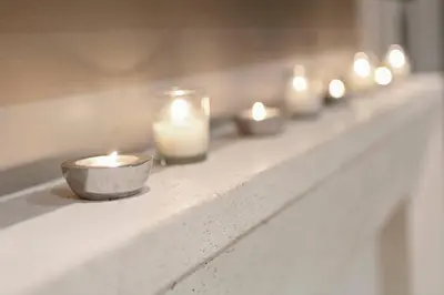 a shelf with candles and a row of candles at Cozy & Stylish 2br W Hot Tub & Fireplaces in Mississauga