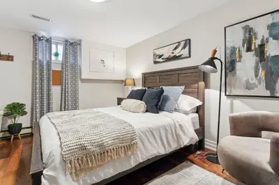 a bedroom with a large bed and a couch at Cozy & Stylish 2br W Hot Tub & Fireplaces in Mississauga