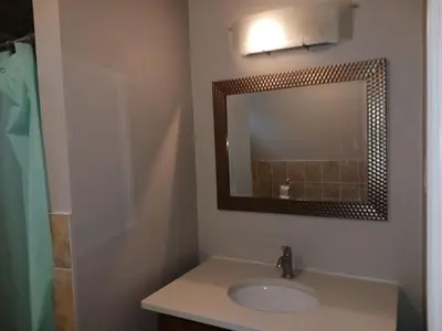a bathroom with a sink and a mirror at Kitchener -WLU BNB-Minutes To University of Waterloo, Conestoga College,Buses,Airport in Waterloo