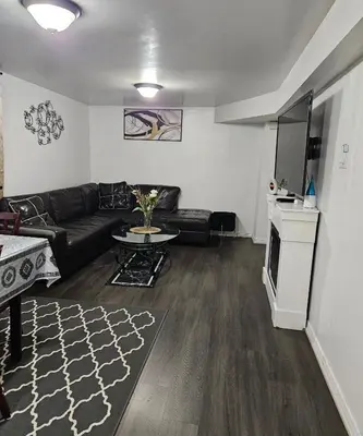 a living room with a couch and a table at Queen bedroom in Toronto
