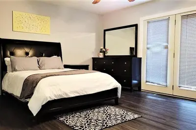 a bedroom with a bed and a dresser and a mirror at Amazing Lakefront cottage on Paradise Lake in Haliburton
