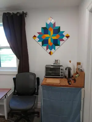 a room with a desk with a microwave and a chair at Soloquester's BnB in Zurich