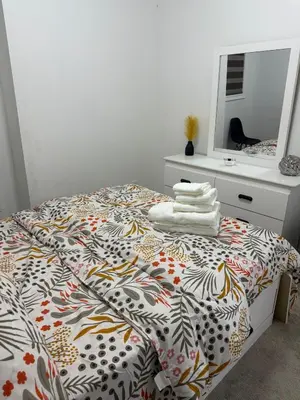 a bedroom with a bed and a dresser and a mirror at Dream Homes in Thorold