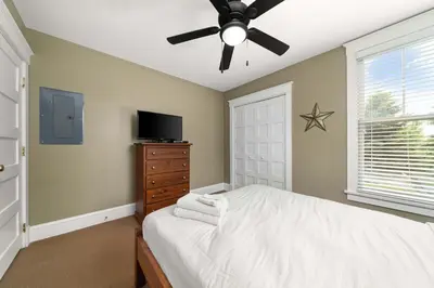 a bedroom with a bed and a ceiling fan at The Chicory - 4 Meadow View in Cherry Valley