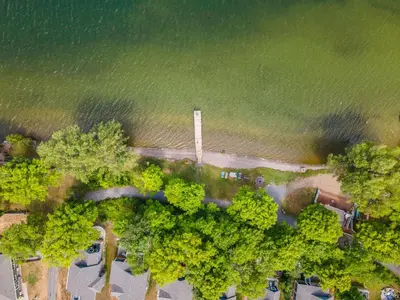 an overhead view of a park with trees and water at The Osprey - 41 Butternut in Cherry Valley