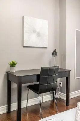 a black desk with a chair in a room at Chic 3BR apartment in Queen West, Downtown Toronto in Toronto