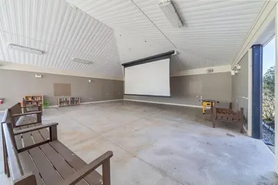 a large room with a white screen in the middle at The Kestrel - 2 Butternut in Cherry Valley