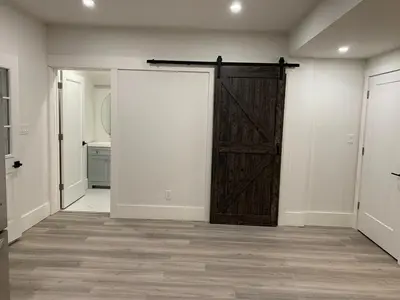 an empty room with a wooden door and a hallway at Century Home in Bracebridge Muskoka in Bracebridge