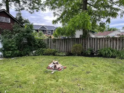 a yard with a teddy bear sitting in the grass at Crystal Beach home in Niagara in Fort Erie