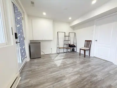an empty room with two chairs and a kitchen at Cozy room with private bath near Don Mills Subway in Toronto