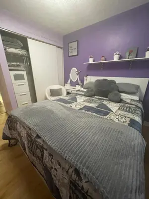 a bedroom with a bed with a teddy bear on it at Welcoming homestay with relaxing private room in Oakville