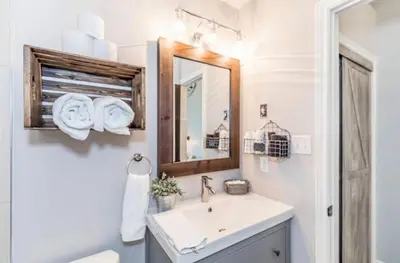 a bathroom with a sink and a mirror at Rustic Loft at Blue in Blue Mountains