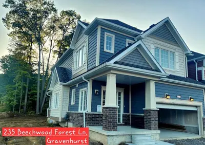 a blue house with a gambrel roof at Whole House 4 Bedrooms 6 beds 3 bath family friendly Quite and relaxation area in Gravenhurst