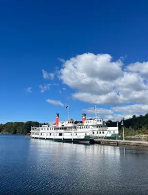 a large white boat is docked in the water at Whole House 4 Bedrooms 6 beds 3 bath family friendly Quite and relaxation area in Gravenhurst