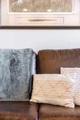 a brown couch with two pillows on it at MR Loft formerly The Lehman Studio Stratford in Stratford