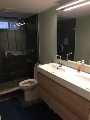 a bathroom with a sink and a toilet and a shower at Upscale 2-Bedroom Basement Apartment in London