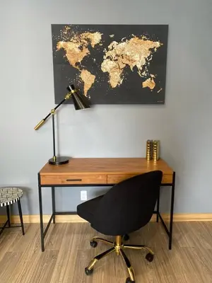 a desk with a lamp and a chair and a map at Stylish Modern 2 bedroom house across from Beach in Hamilton