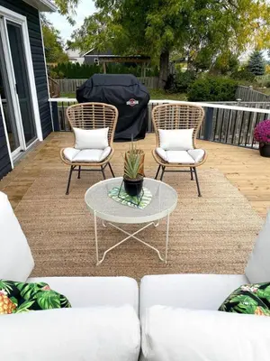 two chairs and a coffee table on a patio at Beautiful Renovated Beach Cottage Home in Hamilton