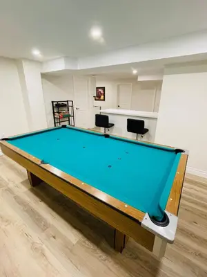 a pool table in the middle of a room at Modern Thorold Apt with Pool Table in Thorold