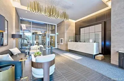 a lobby of a hotel with a bar in the middle at Condo in Yorkville - Newly Furnished Luxury Unit in Toronto