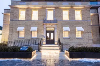 a large brick building with a door in front of it at Condo in Yorkville - Newly Furnished Luxury Unit in Toronto