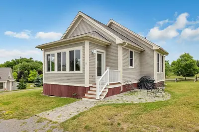a small house with a porch and a lawn at The Meadowlark - 115 Butternut in Cherry Valley