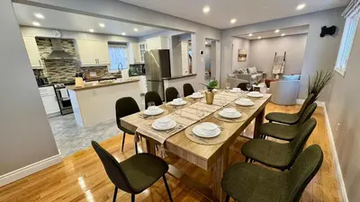 a dining room and kitchen with a table and chairs at Luxury Modern Retreat with Sauna & Modern Amenities in Mississauga
