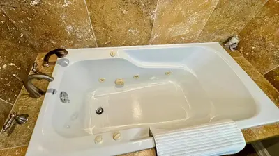 a white bath tub sitting on top of a counter at Luxury Modern Retreat with Sauna & Modern Amenities in Mississauga