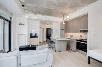 a living room and kitchen with a couch and a table at Studio Gem in the lovely Waterfront Communities in Toronto