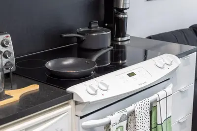 a kitchen with a stove with a pot on it at Exquisitely Furnished 1BR Suite in DWTN Toronto in Toronto