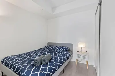 a bedroom with a bed with two pillows on it at Downtown 2 bedroom Condo with Private Balcony in Toronto